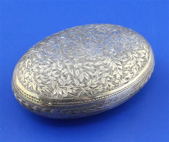 A Victorian chased silver oval tobacco box by George Unite, 2.5 oz.